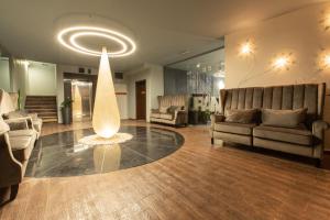 a lobby with couches and a table in a room at Ores Boutique Hotel in Bansko