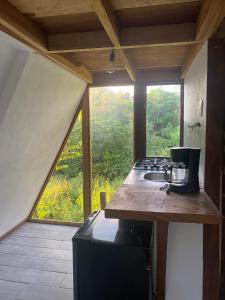 a kitchen with a counter with a stove and a window at Queen house in Nosara