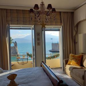 a bedroom with a bed and a view of the ocean at Casa da Sogno Elegant Studio in Nafpaktos