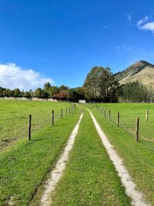 a dirt road in a field with a fence at Off the Beaten Track B&B in Canvastown +12 photos