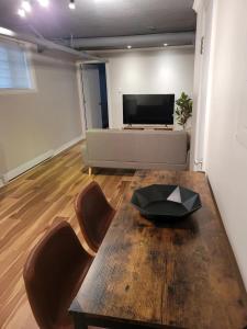 a living room with a table and a couch at Cozy apartment in Ahuntsic with Free Parking and near metro station in Montreal