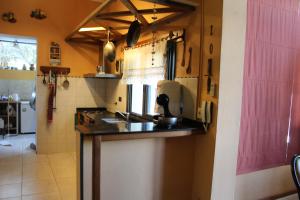 a kitchen with a sink and a counter top at Huayra in Deán Funes