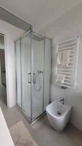 a bathroom with a glass shower and a sink at Maison Ginevra in Pompei
