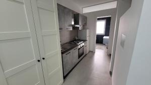 a kitchen with white cabinets and a stove top oven at Maison Ginevra in Pompei