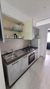 a kitchen with a sink and a stove at Maison Ginevra in Pompei