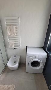 a bathroom with a washing machine and a sink at Maison Ginevra in Pompei +4 photos