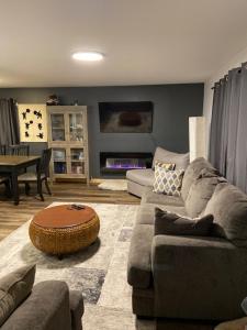 a living room with a couch and a table at Bears Den Guest House in Churchill