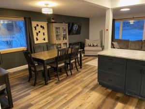 a kitchen and dining room with a table and chairs at Bears Den Guest House in Churchill