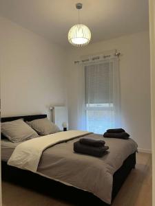 a bedroom with a bed with two towels on it at Chez David in Villejuif