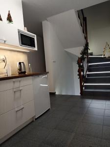 a kitchen with a staircase in the back of a house at PRZY POTOKU -noclegi in Białka Tatrzanska