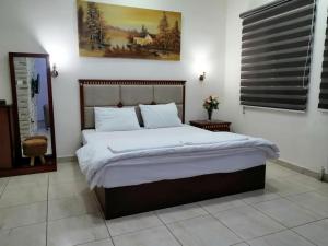 a bedroom with a large bed with white sheets at Nojoom Hotel in Amman