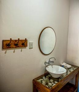 a bathroom with a sink and a mirror at Casa y Departamentos Valle del Bermejo in Villa Unión