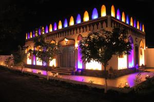 a building with purple and blue lights on it at Djorff Garden Villa in Luxor