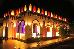 a building with colorful lights on it at night at Djorff Garden Villa in Luxor