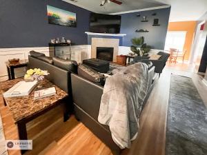 a living room with a couch and a fireplace at 4 - Bed home with Cali King Bed, 12 mins to DTWN in Atlanta +42 photos