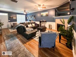 a living room with a couch and a fireplace at 4 - Bed home with Cali King Bed, 12 mins to DTWN in Atlanta