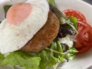 a fried egg on a salad with lettuce and tomato at irodori in Matsumoto
