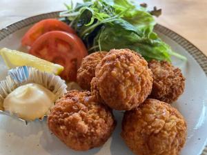 a plate of food with meatballs and a salad at irodori in Matsumoto
