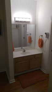 a bathroom with a sink and a large mirror at Two bedroom Sea Trail condo in Sunset Beach in Sunset Beach