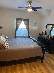 a bedroom with a bed and a ceiling fan at Two bedroom Sea Trail condo in Sunset Beach in Sunset Beach