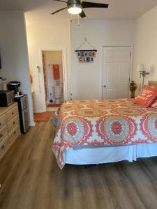 a bedroom with a bed with a comforter on it at Two bedroom Sea Trail condo in Sunset Beach in Sunset Beach