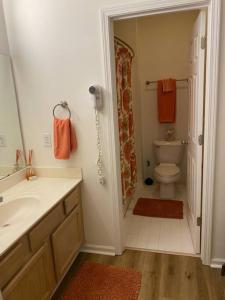 a bathroom with a sink and a toilet and a shower at Two bedroom Sea Trail condo in Sunset Beach in Sunset Beach