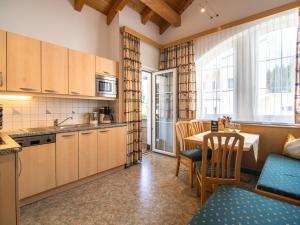 a kitchen with a table and chairs and a kitchen with a dining room at Haus Irmgard 1 in Mathon