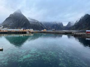 a large body of water with mountains in the background at Rostad Retro Rorbuer in Reine