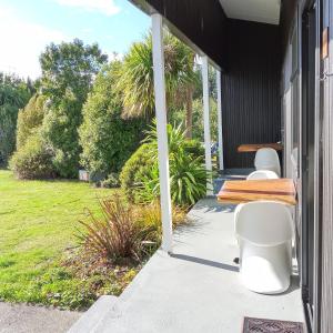 two toilets sitting on the porch of a house at Last Light Lodge in Tuatapere
