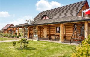 a log cabin with a picnic table in the yard at Lovely Apartment In Jezierzany With Kitchen in Jezierzany