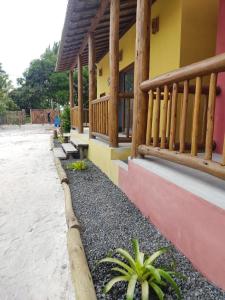 un edificio con un porche y algunas plantas delante de él en Casas Delu Caraiva, en Caraíva