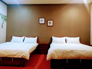 Postel nebo postele na pokoji v ubytování Ju Jia Xiao Zhan Homestay