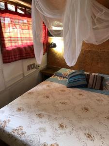 a bedroom with two beds and a window at Cabaña Iris in La Paloma