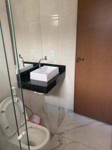 a bathroom with a sink and a toilet at Bela Casa com 3 quartos mobiliada na Zona Leste in Teresina