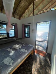 a bedroom with a bed and a view of the ocean at Blue Sky Resort in Ko Chang
