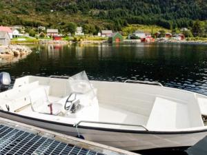 a white boat is docked on the water at 4 person holiday home in MÅLØY-By Traum in Måløy +5 photos
