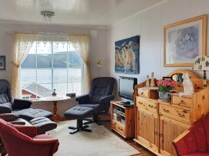 a living room with two chairs and a television at 7 person holiday home in Rossfjordstraumen in Straumen