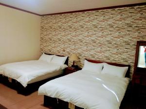 Postel nebo postele na pokoji v ubytování Ju Jia Xiao Zhan Homestay