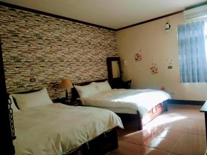 Postel nebo postele na pokoji v ubytování Ju Jia Xiao Zhan Homestay