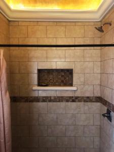 a tiled shower with a fireplace in a bathroom at Colonial Charm in Antigua - women only in Antigua Guatemala