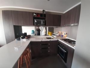 a kitchen with a person taking a picture at laguna del mar, la serena in La Serena