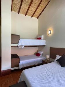 2 camas en una habitación de hotel con 2 camas en La Finka Cajamarca en Cajamarca