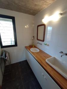 a bathroom with a sink and a mirror at LA AGÜITA PERDIDA in Raco