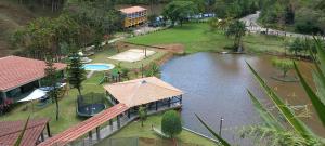 an aerial view of a park with a pond and a house at Hotel Fazenda Bonanza in Engenheiro Paulo de Frontin