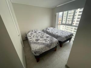 a small room with two stools and a window at Costa Herradura in Coquimbo