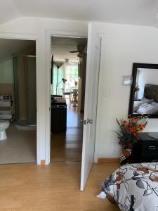 a room with a bed and a hallway with a bathroom at Get Together gt Sylvan Beach, Usa in Sylvan Beach