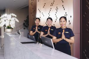 a group of women standing in front of a counter praying at Fifth Pattaya Jomtien By Shiwalai Int in Jomtien Beach