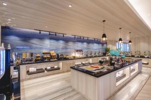 a large kitchen with a buffet in a restaurant at Fifth Pattaya Jomtien By Shiwalai Int in Jomtien Beach