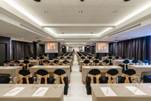 a banquet hall with tables and chairs and two screens at Fifth Pattaya Jomtien By Shiwalai Int in Jomtien Beach