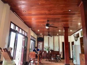 a living room with a ceiling fan and a table at Luang Prabang Pangkham Lodge in Luang Prabang